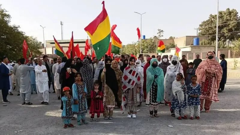Protesters carry Balochistan National Party and Baloch flags during a demonstration over the Sorab killings